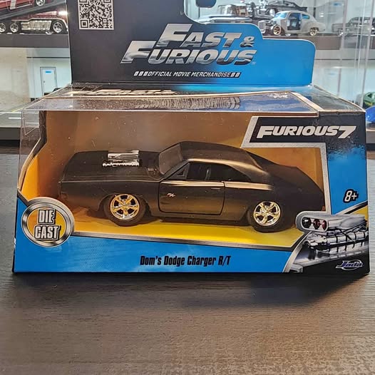 Die-cast toy car model in retail box with blue graphics, Dom's Dodge Charger R/T