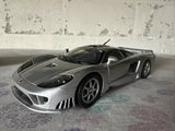 Silver diecast model sports car, front three-quarter view, detailed wheels and grille