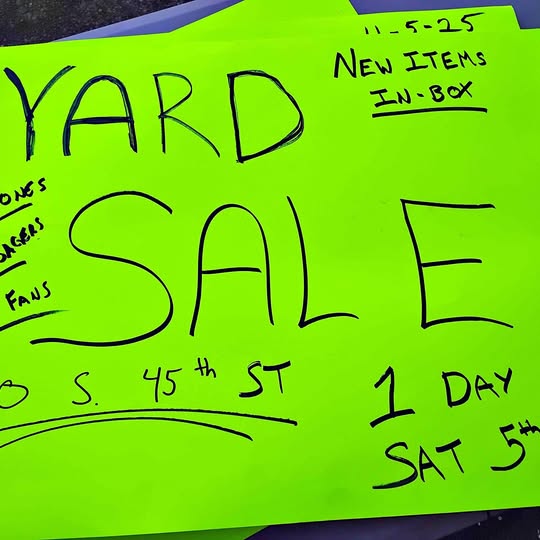 Neon green yard sale sign with handwritten SALE text and dates