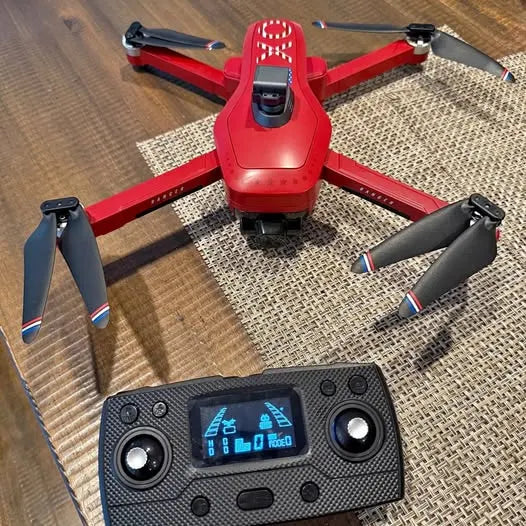 Red quadcopter drone with black controller remote