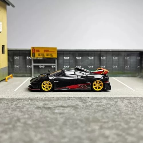 Black diecast model car with red accents and yellow wheels, side view