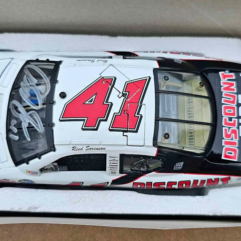 White diecast race car with red number 41 and Reed Sorenson autograph graphic