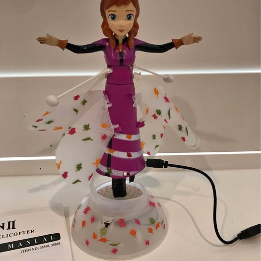 Anna hand-motion helicopter toy with purple outfit and white spinning base