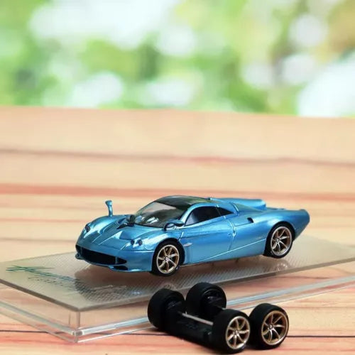 Blue die-cast sports car model with spare wheels