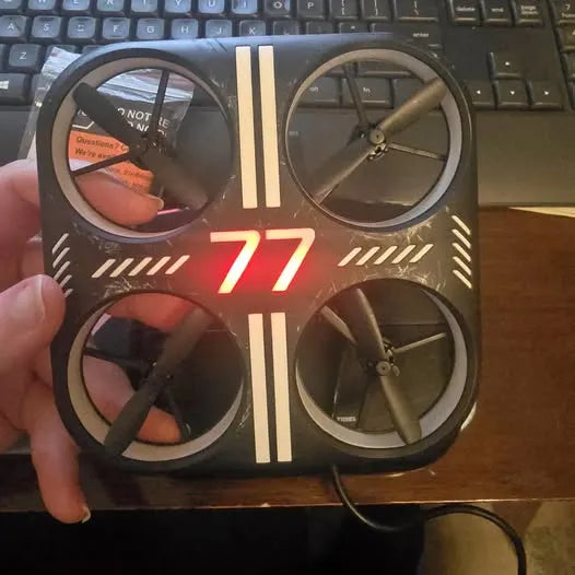 LED glow stunt drone with four propellers and red '77' LED display, black body