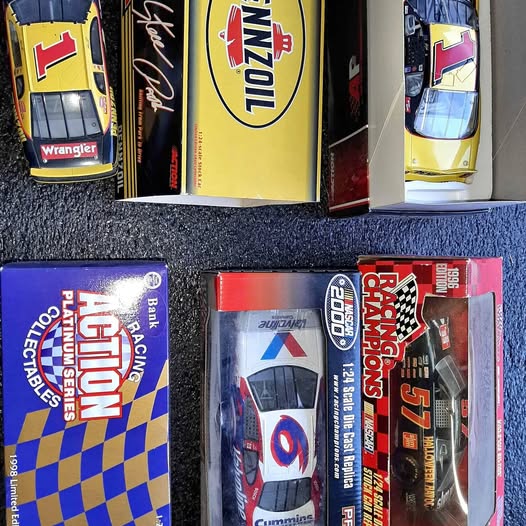 Racing diecast model car in blister box, red and black with white graphics