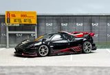 Diecast sports car model, black with red accents and racing decals