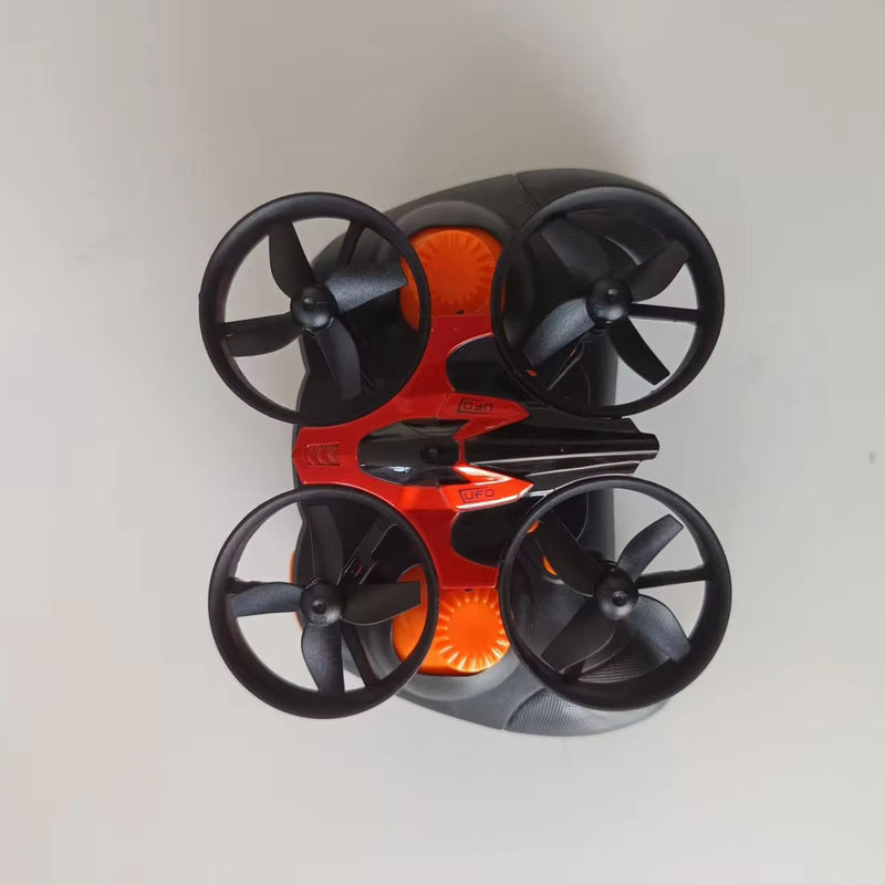 Mini drone with 4 orange propellers and red-and-black body