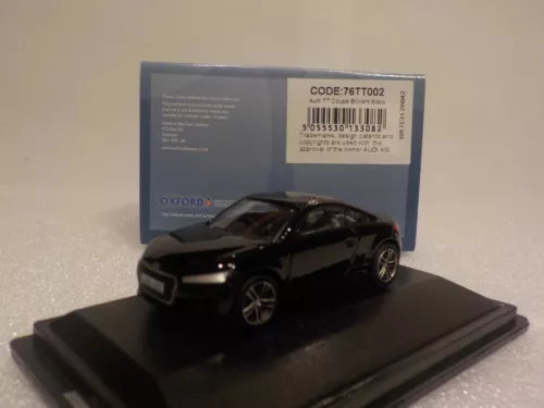 Black diecast Audi TT coupe model on display base, front three-quarter view