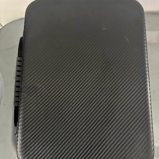 Black quadcopter drone housing with textured finish and rounded corners