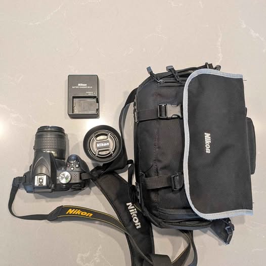 Nikon D3400 DSLR camera kit with bag, strap, and charger