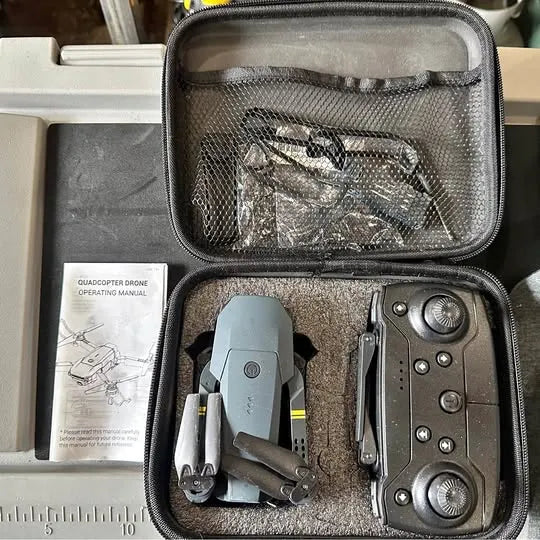 Mini drone kit in hard carrying case with drone, controller, and manual