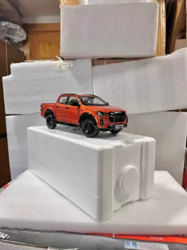 1:18 scale orange Isuzu D-MAX pickup truck diecast model car on display block