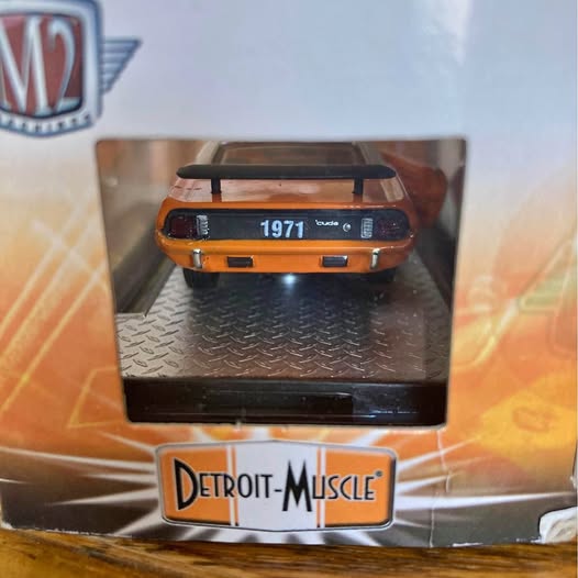 Orange and black 1971 diecast muscle car model with front grille detail, in box