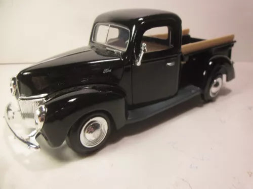 Black 1:24 diecast pickup truck model with chrome grille and front wheels