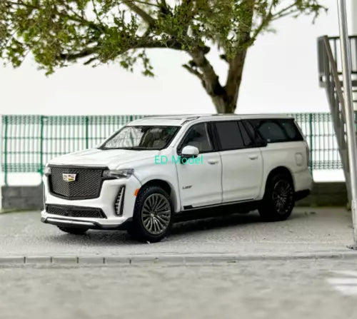 White diecast SUV model car with chrome grille and black trim, front three-quarter view