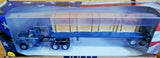 Blue diecast semi-truck model in open box, visible chassis and wheels
