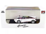 1:64 diecast roadster model car, white with red accents, in display case