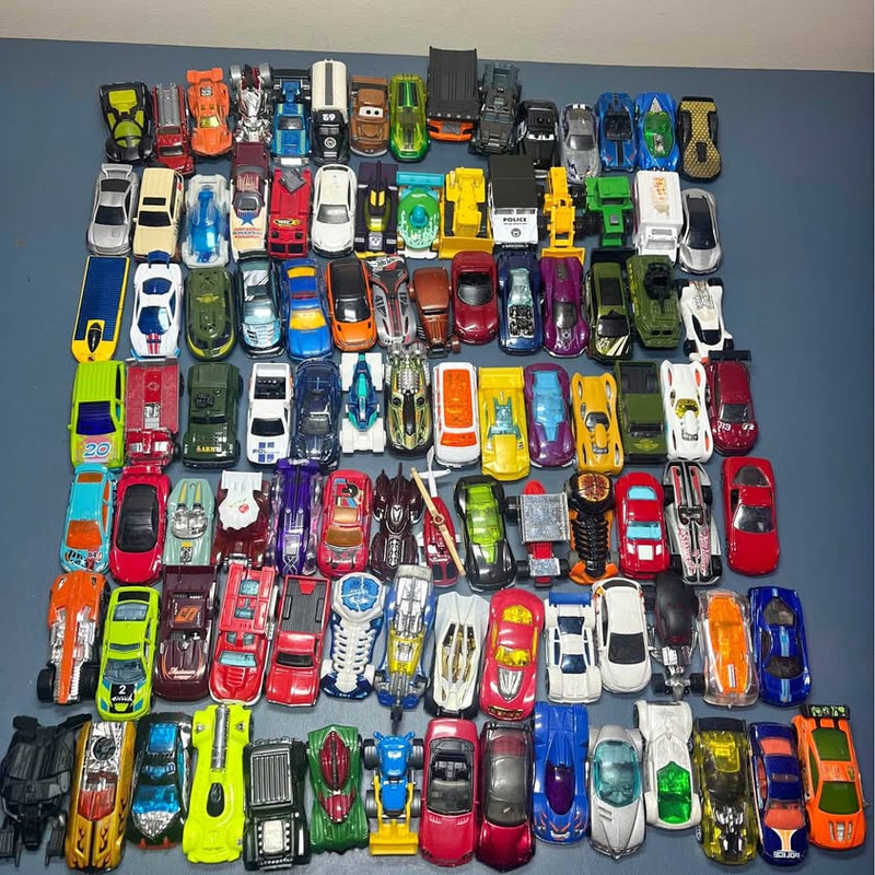 Assorted Hot Wheels and Matchbox diecast cars, mixed colors, front views