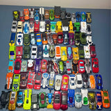 Assorted Hot Wheels and Matchbox diecast cars, mixed colors, front views