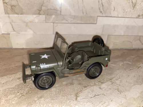 Diecast Jeep Willys 4.5-inch vehicle, dark green with white star decals and open top.