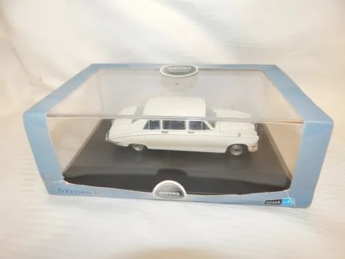 White diecast sedan model in display box with clear window