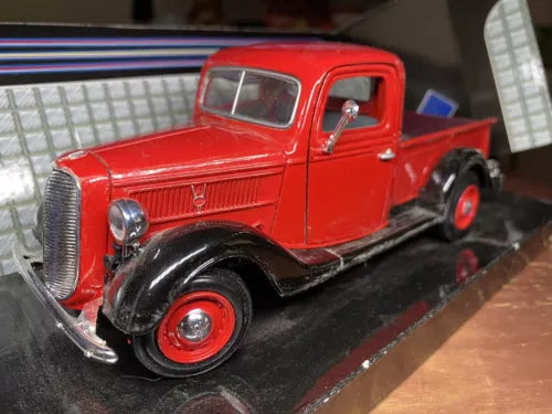 Red 1937 Ford pickup die-cast truck, front three-quarter view, chrome grille, black tires