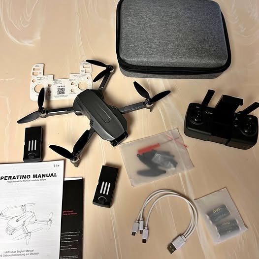 4K GPS drone kit with controller, spare batteries, cables, and carrying case