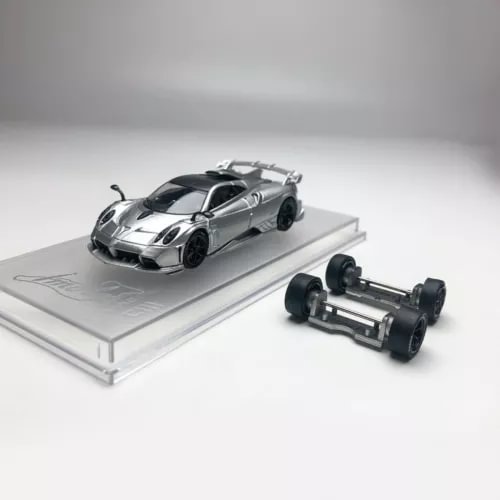 Silver 1/64 diecast sports car model with accessory chassis parts