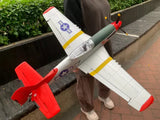 RC combat aircraft model plane with white body, red wings, and front prop