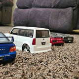 1/24 scale diecast car, white SUV model with rear view and chrome wheels