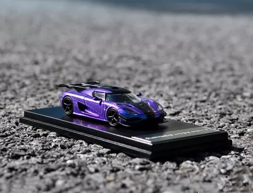 Purple diecast sports car model on black display stand