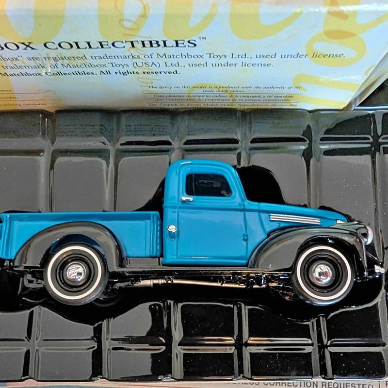 Blue diecast pickup truck with chrome bumper, trim, and spoked wheels