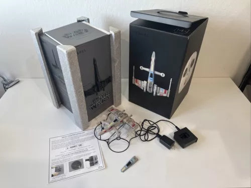 RC quadcopter drone kit in box with accessories, cables, and controller