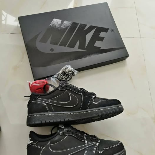 Black high-top sneakers with white swoosh logo and lace-up closure
