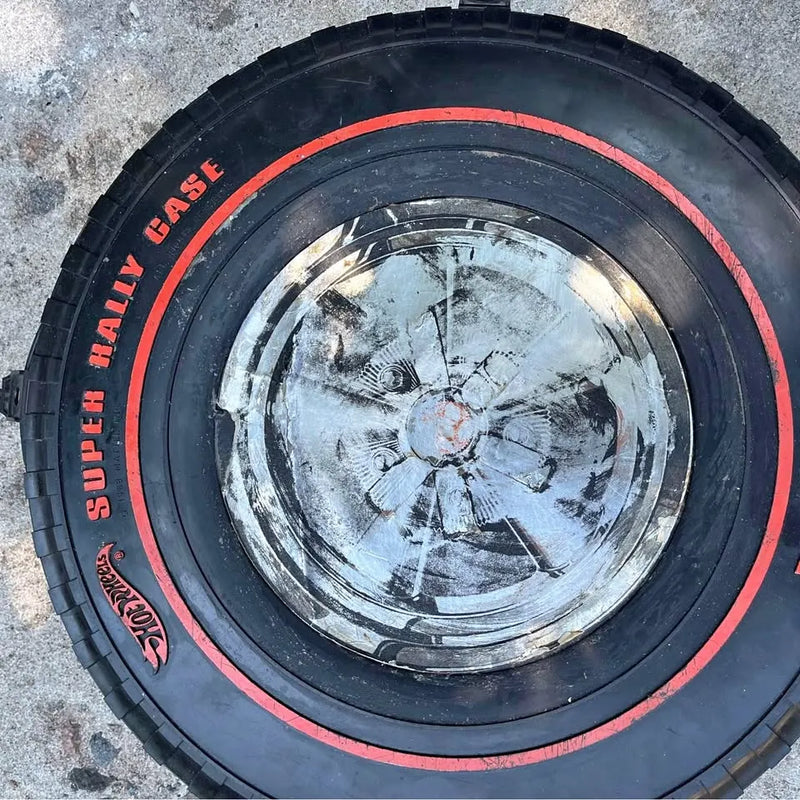 Black tire with silver wheel and red rim stripe detail