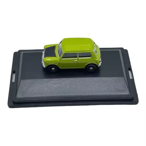 Green diecast mini car model on black display base, front view