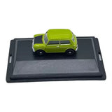 Green diecast mini car model on black display base, front view