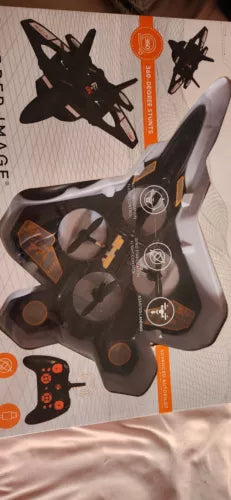 Black stunt drone with handheld remote control shown on retail box