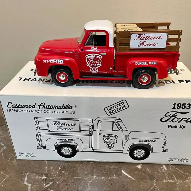 Red 1:34 diecast 1953 Ford flathead pickup truck model in open box packaging