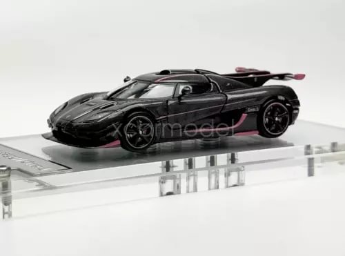 1:64 scale sports diecast car, black with pink accents, side view
