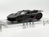 1:64 scale sports diecast car, black with pink accents, side view