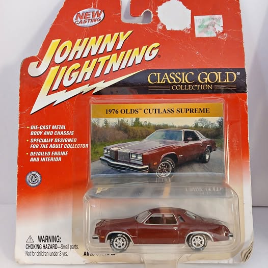 Diecast 1976 Olds Cutlass Supreme toy car in clear blister with red packaging