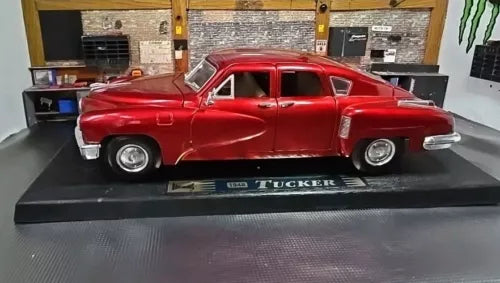 Red Tucker Torpedo 1:18 diecast model car on display base, silver grille and trim