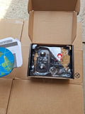 Micro quadcopter drone kit in open cardboard box with plastic-wrapped components