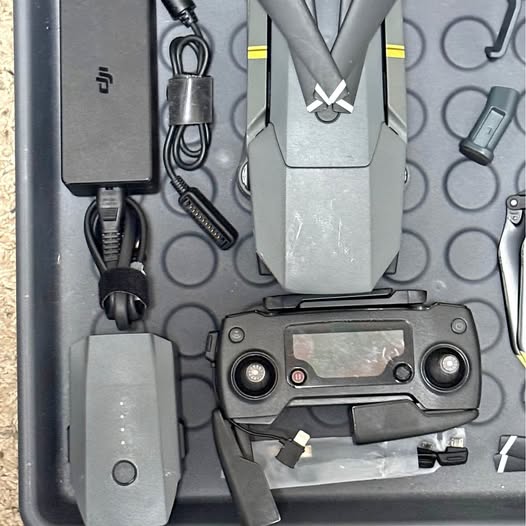 Drone controller with screen and joysticks, plus cables and mount accessories