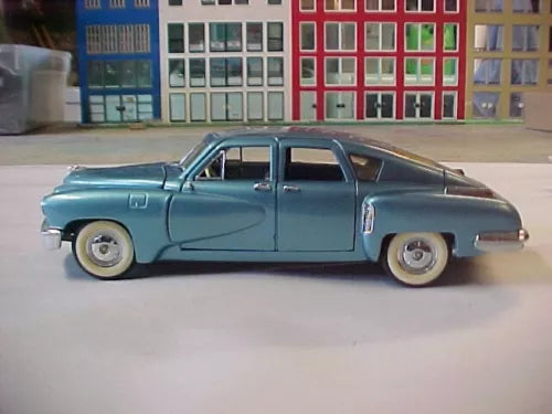 Light blue 1948 Tucker diecast model car, 1:24 scale, side profile