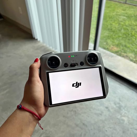 DJI drone remote controller with screen, joysticks, and dual antenna ports