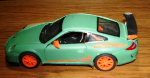 Toy diecast car with green body and orange wheels, front three-quarter view.