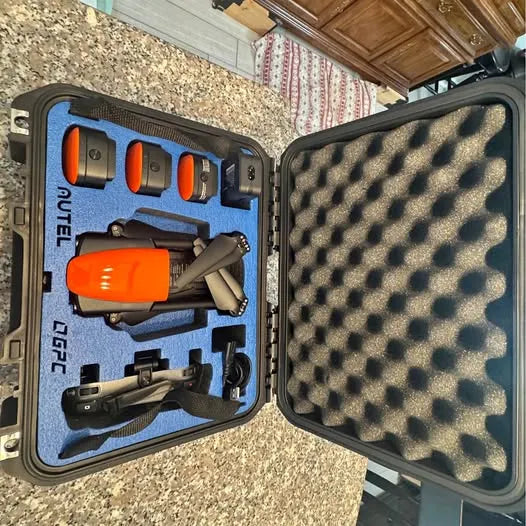 Hard-shell drone carrying case with two drones and orange controllers